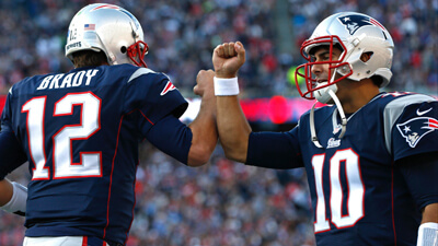 Nov 23, 2014; Foxborough, MA, USA; New England Patriots quarterback Jimmy Garoppolo (10) congratulates quarterback Tom Brady (12) after a touchdown during the second quarter against the Detroit Lions at Gillette Stadium. Mandatory Credit: Greg M. Cooper-USA TODAY Sports